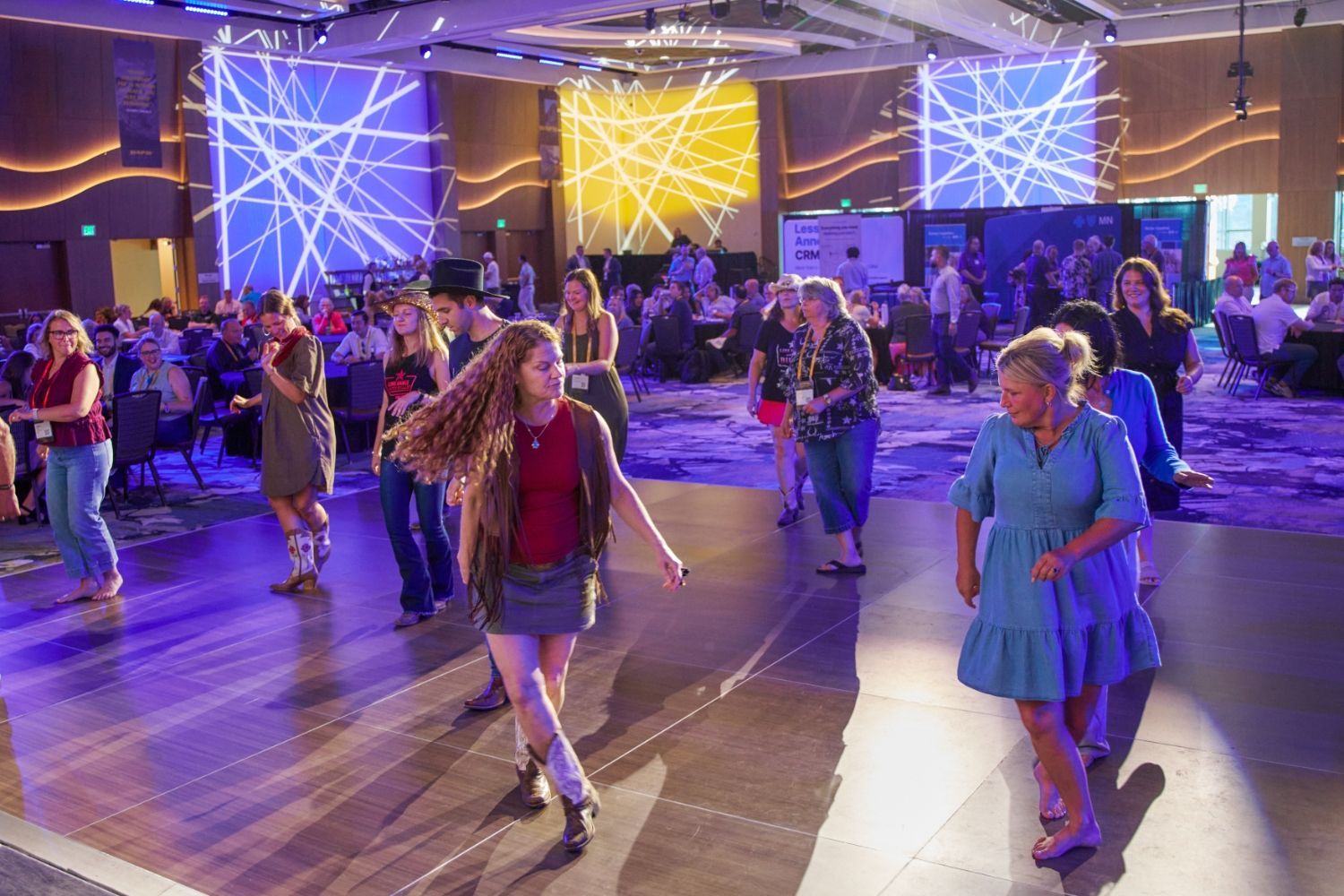 HAP26 attendees line dance during HAPBash